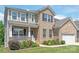 Charming two-story brick home with a manicured lawn, cozy porch, and landscaped yard at 6320 Tilley Way, Matthews, NC 28105