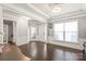 Elegant foyer with hardwood floors, neutral paint, a chandelier, and natural light at 6320 Tilley Way, Matthews, NC 28105