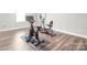 Bright exercise room features wood flooring and exercise equipment at 6320 Tilley Way, Matthews, NC 28105