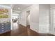 Hallway showcasing elegant trim, hardwood floors, and access to living spaces at 6320 Tilley Way, Matthews, NC 28105