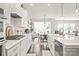 Modern kitchen with white cabinets, stainless steel appliances, and a view of the dining area at 6320 Tilley Way, Matthews, NC 28105
