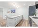 Kitchen island with a white countertop and storage drawers adjacent to more blue cabinets at 6320 Tilley Way, Matthews, NC 28105
