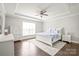 Bright main bedroom features tray ceilings, wood floors, and neutral colors, creating a tranquil and inviting space at 6320 Tilley Way, Matthews, NC 28105