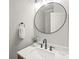 Stylish powder room with marble countertop, modern faucet, and round mirror at 6320 Tilley Way, Matthews, NC 28105