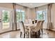 Bright dining room with hardwood floors, seating for six, and large windows providing natural light at 6388 Fairfax Ct, Maiden, NC 28650