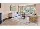 Bright living room with hardwood floors, fireplace, ample seating, and large windows providing natural light at 6388 Fairfax Ct, Maiden, NC 28650