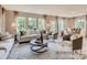 Bright living room with hardwood floors, ample seating, and large windows providing natural light at 6388 Fairfax Ct, Maiden, NC 28650