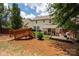 Expansive backyard featuring a wooden bridge, covered patio, and stone patio area at 6422 Gatesville Ln, Charlotte, NC 28270