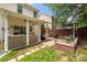 Charming backyard featuring a covered patio with outdoor seating and a stone patio area at 6422 Gatesville Ln, Charlotte, NC 28270