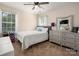 This bedroom features a ceiling fan, neutral walls, and a view to the backyard through a large window at 6422 Gatesville Ln, Charlotte, NC 28270