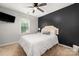 Cozy bedroom with ceiling fan and accent wall at 6422 Gatesville Ln, Charlotte, NC 28270