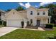 Charming two-story home with a well-manicured lawn and inviting front porch perfect for a Gathering at 6422 Gatesville Ln, Charlotte, NC 28270