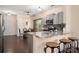 Eat-in kitchen with stainless appliances, breakfast bar, and access to dining area at 6422 Gatesville Ln, Charlotte, NC 28270