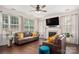 Bright living room featuring fireplace, ceiling fan, and hardwood flooring at 6422 Gatesville Ln, Charlotte, NC 28270