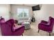 Cozy sitting room with two bright purple chairs and a gray sofa with an ottoman at 6422 Gatesville Ln, Charlotte, NC 28270