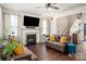 Warm living room featuring fireplace, ceiling fan, hardwood flooring and neutral paint at 6422 Gatesville Ln, Charlotte, NC 28270