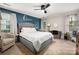 Primary bedroom showcasing a king bed, accent wall, carpet flooring, and a comfortable seating area with lots of light at 6422 Gatesville Ln, Charlotte, NC 28270