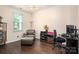 Home office setup with dark hardwood floors, natural light, computer, and comfortable leather chair at 6422 Gatesville Ln, Charlotte, NC 28270