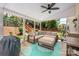Covered patio with outdoor seating, including a cozy sectional, an ottoman, and a ceiling fan at 6422 Gatesville Ln, Charlotte, NC 28270