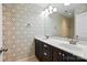 Bathroom with double sink vanity, modern faucets, patterned wallpaper, and large mirror at 809 Ayrshire Ave, Fort Mill, SC 29708