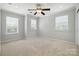 Bright bedroom with neutral walls, carpet, and a ceiling fan for optimal comfort at 809 Ayrshire Ave, Fort Mill, SC 29708