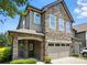 Charming two-story townhome featuring a stone facade, covered entryway, and attached two-car garage at 809 Ayrshire Ave, Fort Mill, SC 29708