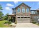 Charming two-story townhome featuring a stone facade, covered entryway, and attached two-car garage at 809 Ayrshire Ave, Fort Mill, SC 29708