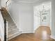 Bright foyer featuring hardwood floors, staircase with carpet runner, and front door with transom window at 809 Ayrshire Ave, Fort Mill, SC 29708