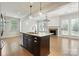 Living room featuring an open kitchen with a view of a fireplace at 809 Ayrshire Ave, Fort Mill, SC 29708