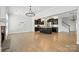 Spacious living room with hardwood floors, adjacent to an open kitchen and a staircase to the upper level at 809 Ayrshire Ave, Fort Mill, SC 29708