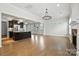 Open concept living space with hardwood floors, modern lighting, and a fireplace at 809 Ayrshire Ave, Fort Mill, SC 29708