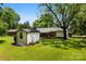 Spacious backyard with mature trees, a storage shed, and partial fencing at 814 W Gold St, Kings Mountain, NC 28086