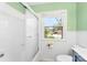 Clean bathroom featuring a shower-tub with white tile and a bright window, designed for comfort and functionality at 814 W Gold St, Kings Mountain, NC 28086