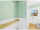 Fresh bathroom with green walls, white wainscoting, and a shower-tub combination, blending classic elements for a soothing experience at 814 W Gold St, Kings Mountain, NC 28086