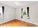 Neutral bedroom featuring hardwood floors, two windows and contrasting curtains at 814 W Gold St, Kings Mountain, NC 28086