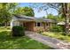 Brick home featuring a covered carport and a convenient ramp, blending accessibility with classic design and a serene setting at 814 W Gold St, Kings Mountain, NC 28086