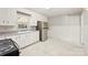 Well-lit kitchen with white cabinets, stainless steel appliances, and elegant marble-look flooring, offering a stylish cooking space at 814 W Gold St, Kings Mountain, NC 28086