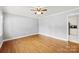 Bright living room featuring hardwood floors, neutral walls, and a ceiling fan, creating a comfortable and inviting atmosphere at 814 W Gold St, Kings Mountain, NC 28086