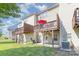 The backyard has a green lawn, an AC unit, and covered patios and decks above at 9720 Walkers Glen Nw Dr, Concord, NC 28027