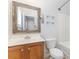 Bathroom with combined tub and shower, white toilet and sink with dark vanity at 9720 Walkers Glen Nw Dr, Concord, NC 28027