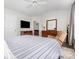 This primary bedroom features a ceiling fan, dresser, television and a recliner at 9720 Walkers Glen Nw Dr, Concord, NC 28027