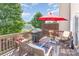 The wooden deck has an outdoor table, chairs, BBQ grill and red umbrella at 9720 Walkers Glen Nw Dr, Concord, NC 28027
