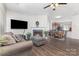 Open-concept living area with a fireplace, seamlessly flowing into the dining space and kitchen at 9720 Walkers Glen Nw Dr, Concord, NC 28027