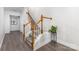 Elegant staircase featuring wooden handrails and white spindles, complemented by stylish floors at 9720 Walkers Glen Nw Dr, Concord, NC 28027
