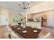 Open-concept dining area with view to living room and kitchen, hardwood floors, and stylish decor, great for entertaining guests at 975 Pine Knoll Rd, Fort Mill, SC 29715