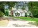 Charming white home with lush green landscaping and a long driveway leading to the property at 975 Pine Knoll Rd, Fort Mill, SC 29715