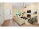 Bright living room with vaulted ceiling, fireplace, large windows, and modern furnishings, offering a cozy and inviting atmosphere at 975 Pine Knoll Rd, Fort Mill, SC 29715