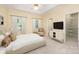 Serene main bedroom with tray ceiling, neutral decor, walk-in closet, and ample natural light, providing a comfortable retreat at 975 Pine Knoll Rd, Fort Mill, SC 29715