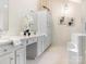 Bright bathroom featuring double sinks, white cabinets, and a separate tub and shower at 10333 Scott Gate Ct, Charlotte, NC 28277