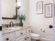 Bathroom with a white vanity, framed mirror and decorative wall art at 10333 Scott Gate Ct, Charlotte, NC 28277